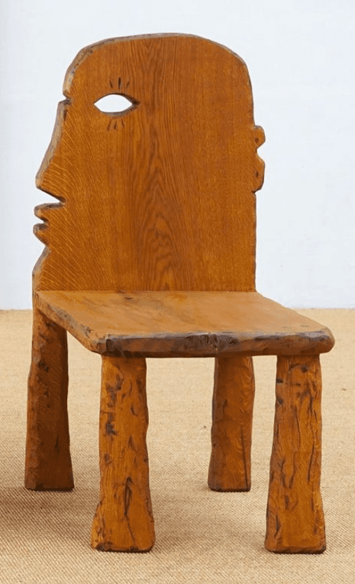A distinctive carved wooden chair crafted from medium-brown oak, featuring an anthropomorphic backre… — free STL 3D model