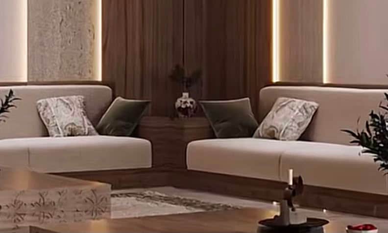 A modern two-seater sofa featuring light beige upholstered cushions and a contrasting dark wood plin… — free GLTF 3D model