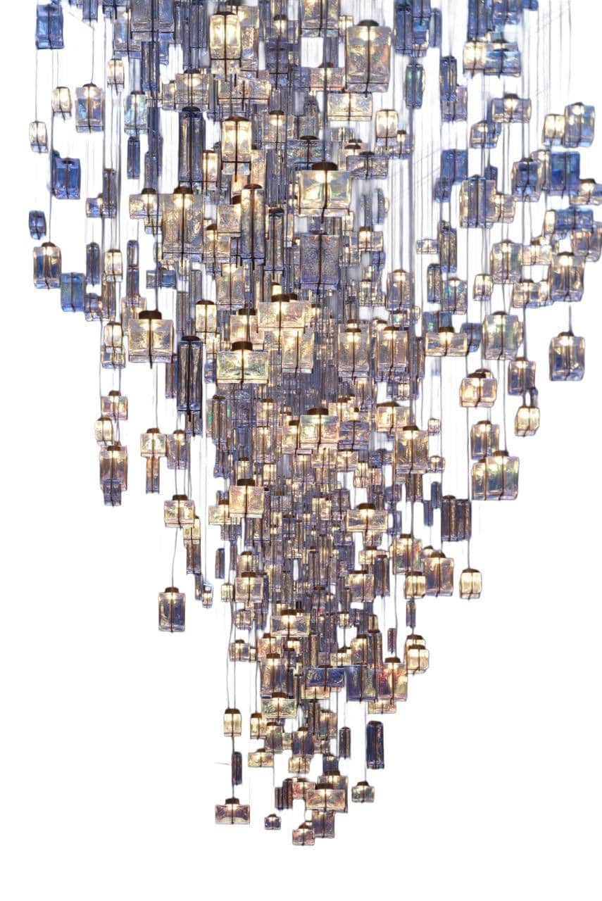 A grand, multi-tiered chandelier featuring numerous individual lighting elements suspended at varyin… — 3D model