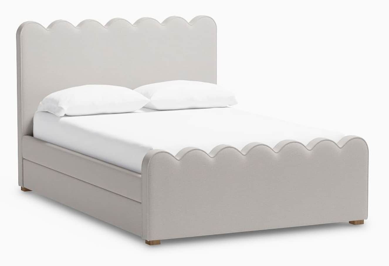 A fully upholstered bed frame with a scalloped headboard and footboard. The bed features a built-in… — free FBX 3D model