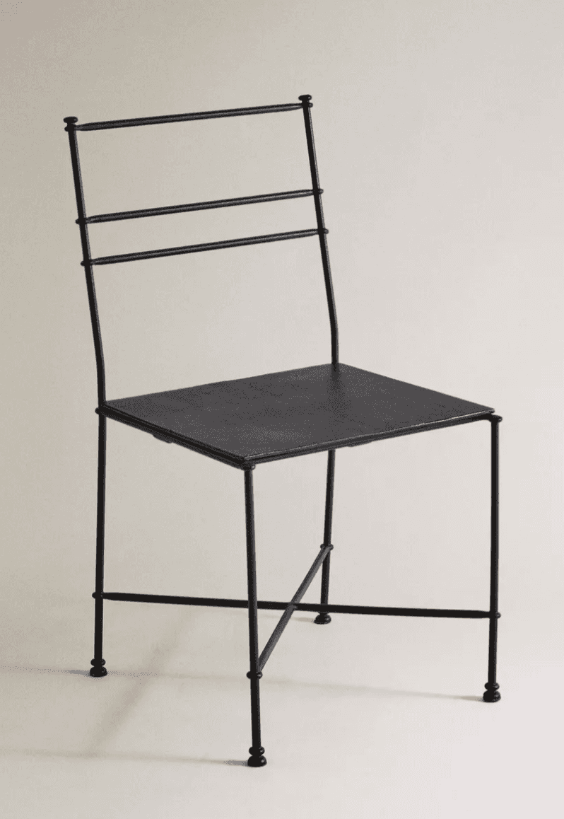 A minimalist side chair constructed from black metal. The seat is a flat, rectangular surface. The b… — 3D model