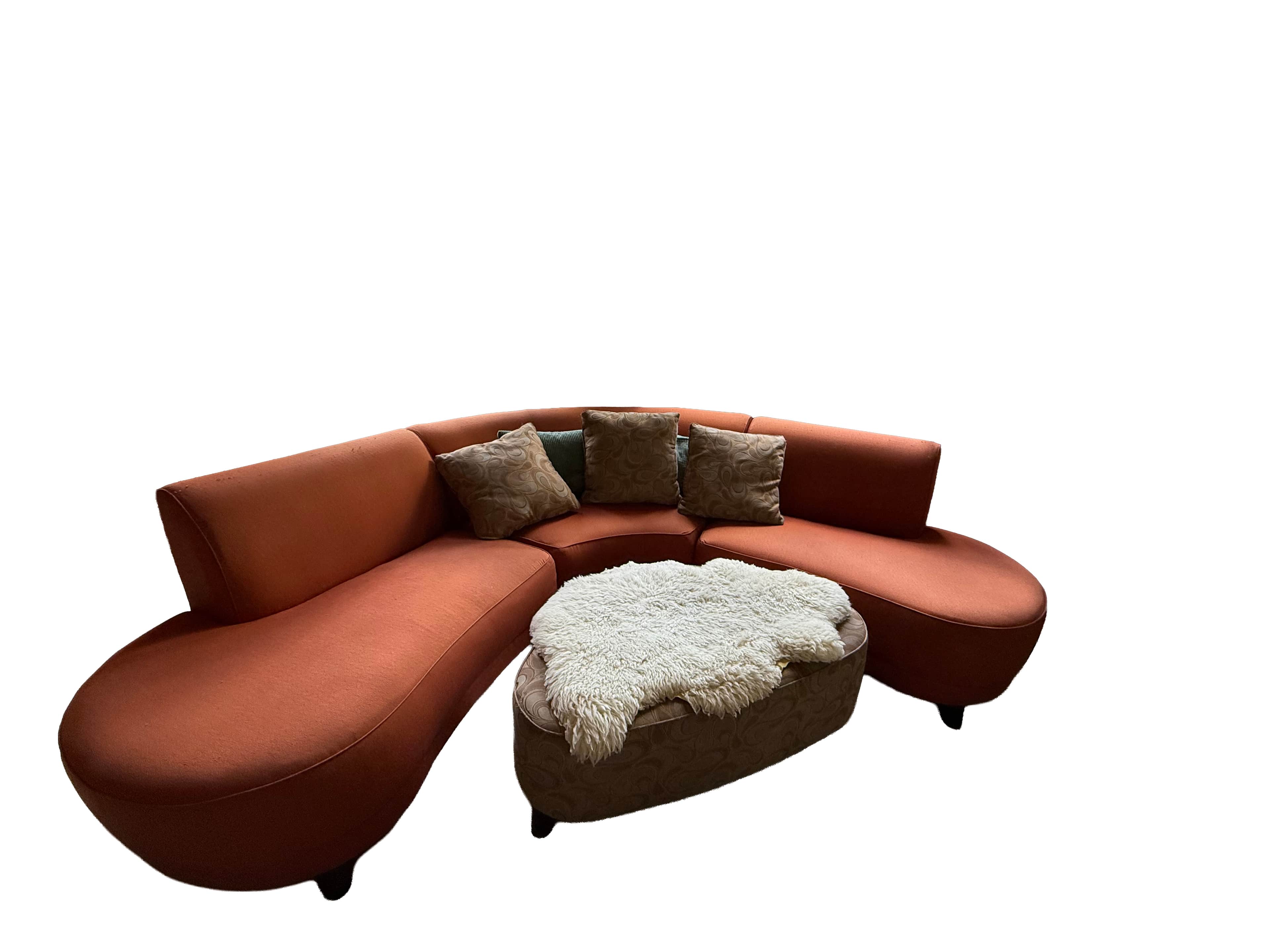 A terracotta-colored, multi-piece curved modular sectional sofa is depicted, designed with a fluid,… — 3D model