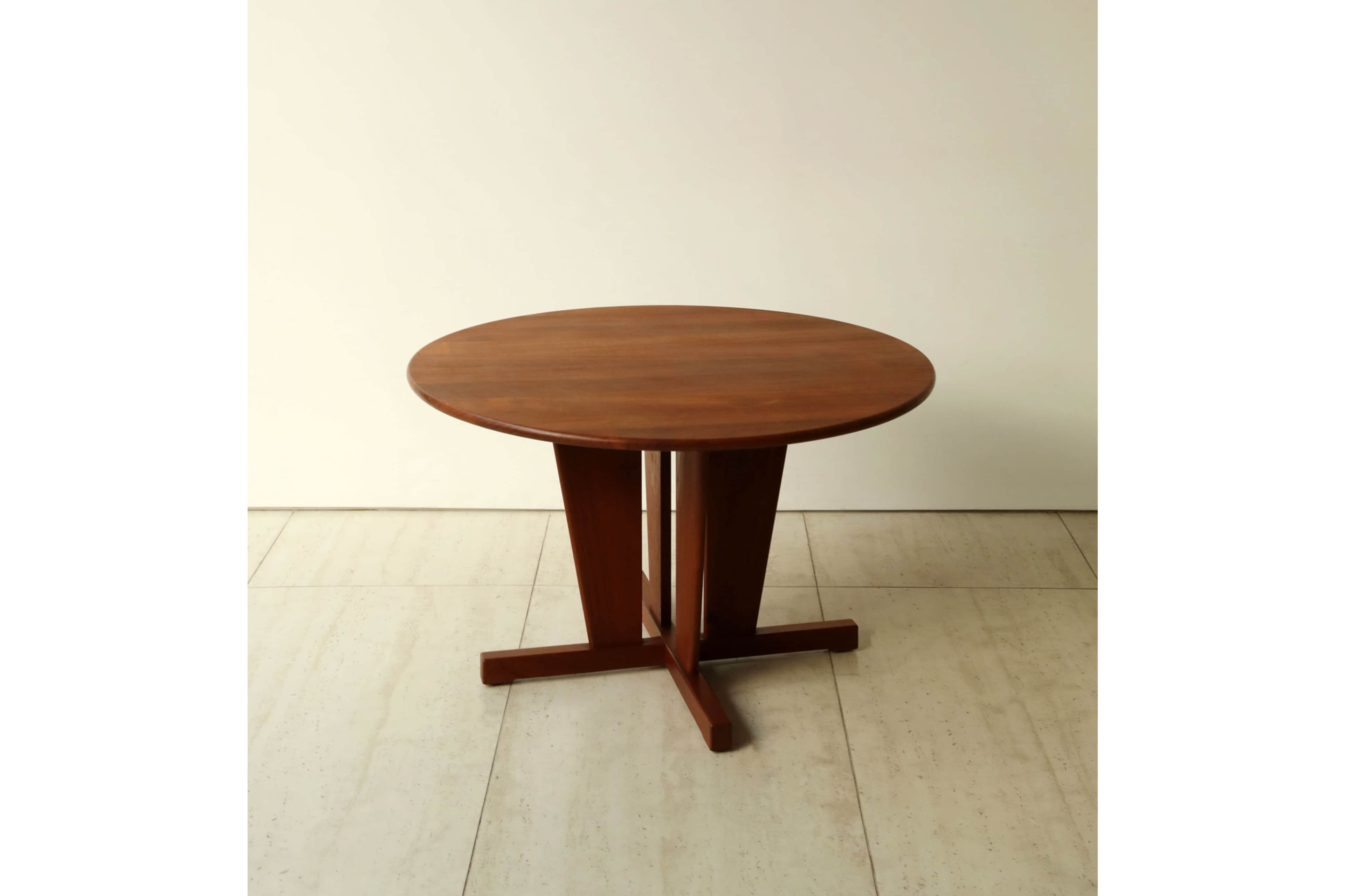 A round wooden table with a sturdy pedestal base, featuring a reddish-brown finish. The top is circu… — 3D model