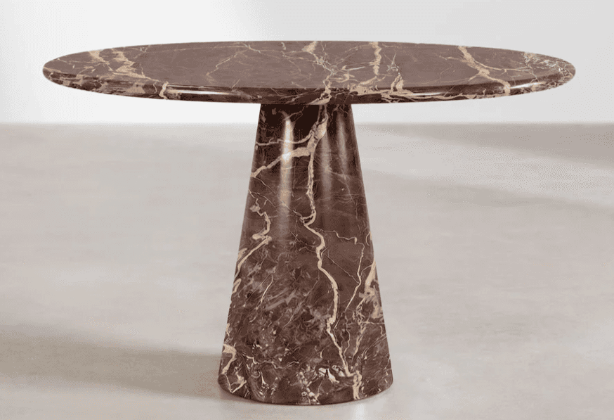 A pedestal table with a round, flat top and a single, tapered pedestal base. The surface exhibits a… — 3D model