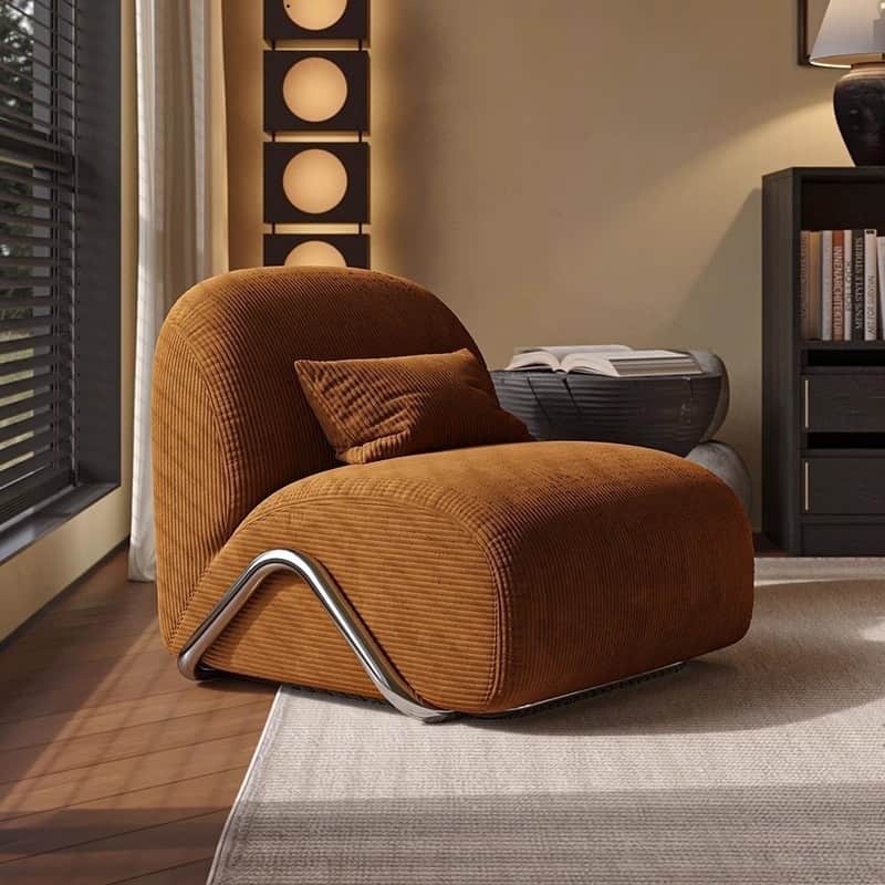 A modern lounge chair featuring rust-colored, ribbed corduroy upholstery, a rounded backrest, and in… — free GLTF 3D model