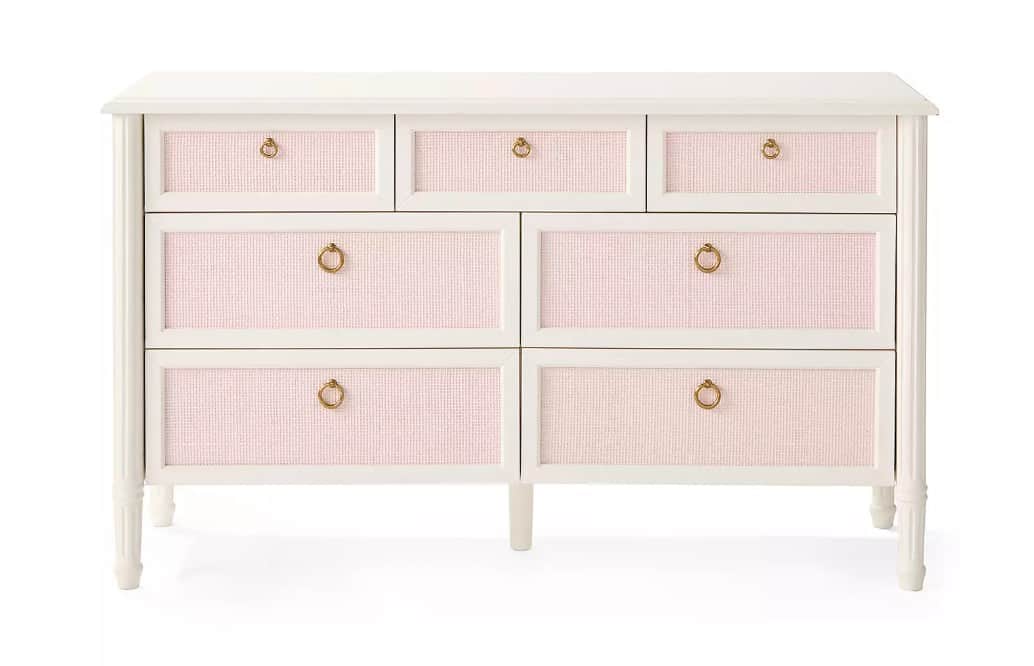 A seven-drawer dresser featuring a white painted frame and pink woven raffia-like panels on the draw… — 3D model
