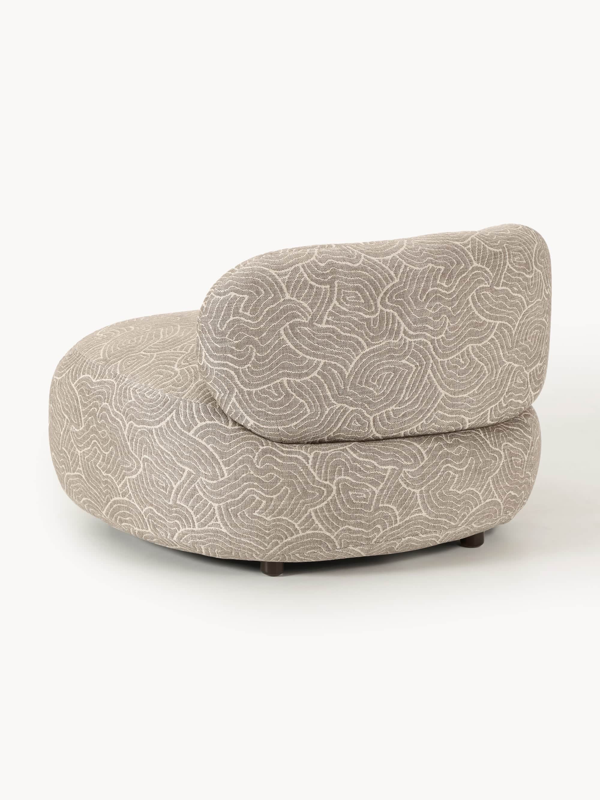 A modern, rounded armchair with a distinctive swirling pattern upholstery. It features a low profile… — free OBJ 3D model
