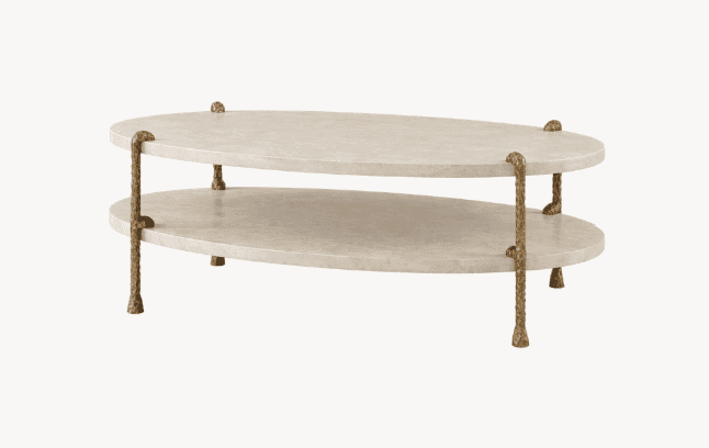 A two-tiered oval coffee table with a textured, light-colored surface and ornate metallic legs. The… — free BLEND 3D model