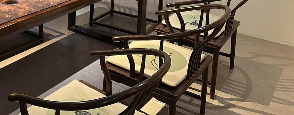 A traditional Chinese horseshoe-back armchair with a dark wood frame and an upholstered seat cushion… — 3D model