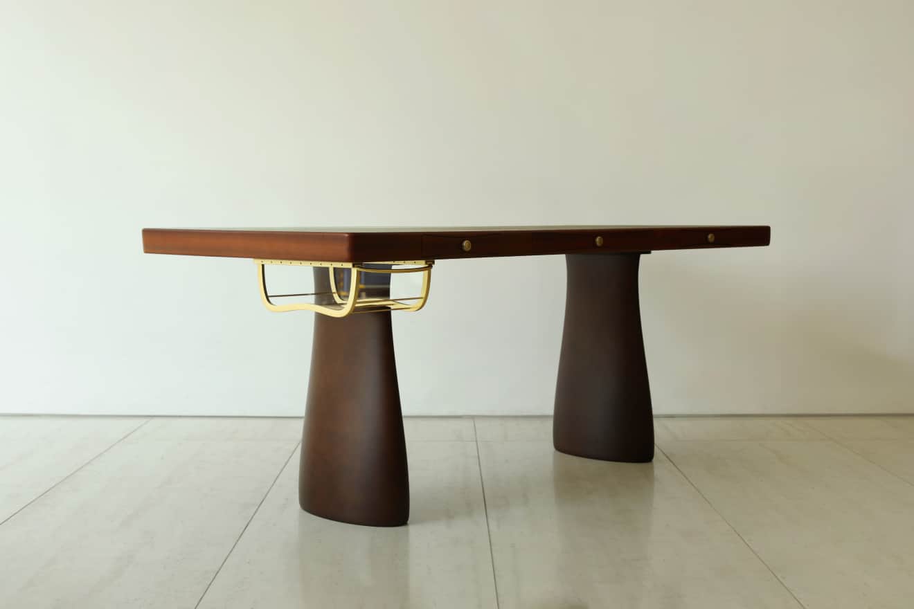 A sleek, dark brown executive desk featuring a substantial rectangular top supported by two wide, ta… — 3D model