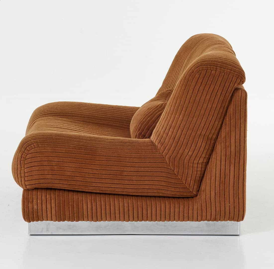 A brown, heavily upholstered lounge chair component with a ribbed corduroy fabric texture, featuring… — 3D model
