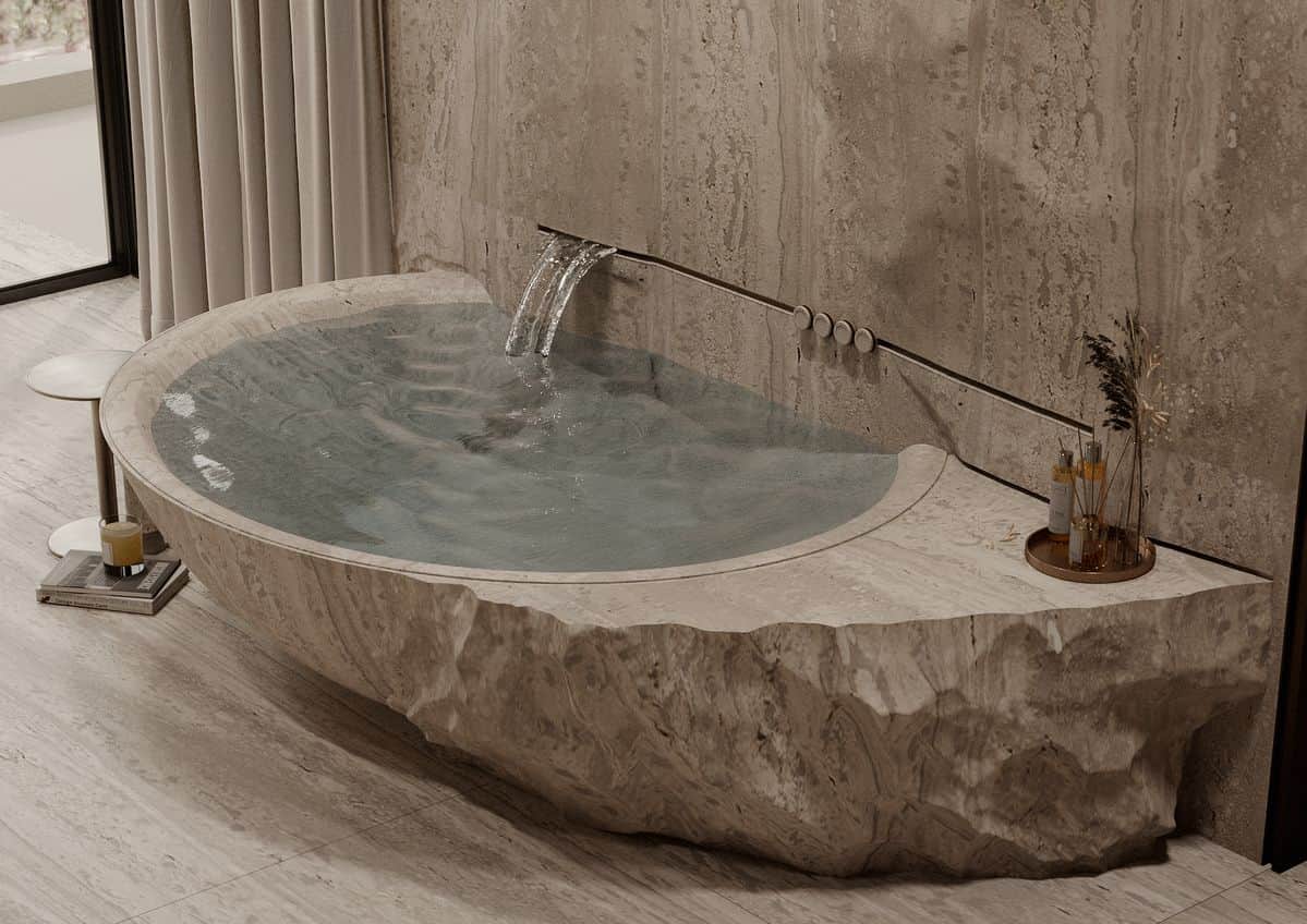 A freestanding bathtub carved from natural stone, with a rough, chiseled exterior resembling a rock… — free FBX 3D model