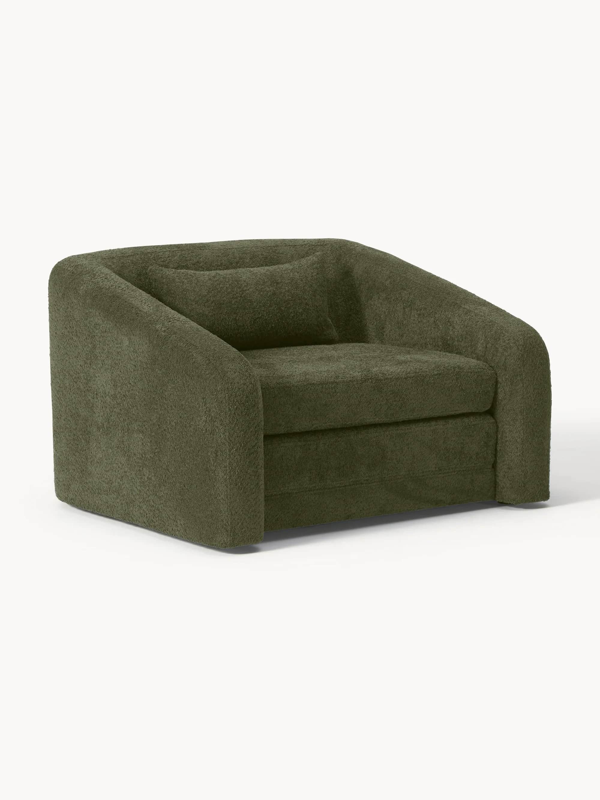 A modern, rounded armchair with a plush, textured upholstery and a single matching throw pillow. The… — free OBJ 3D model