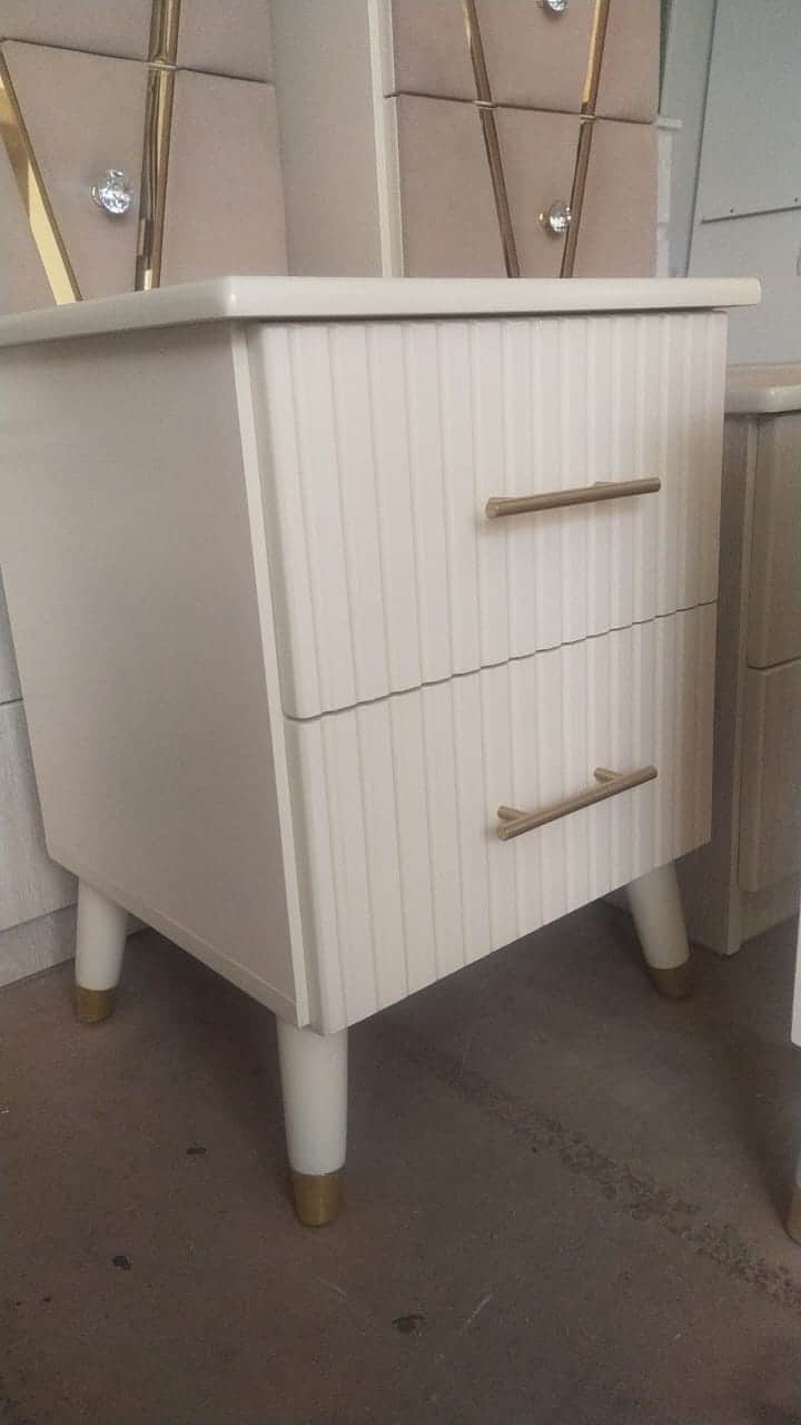 A modern two-drawer nightstand featuring a light neutral finish and elegant design details. The fron… — 3D model
