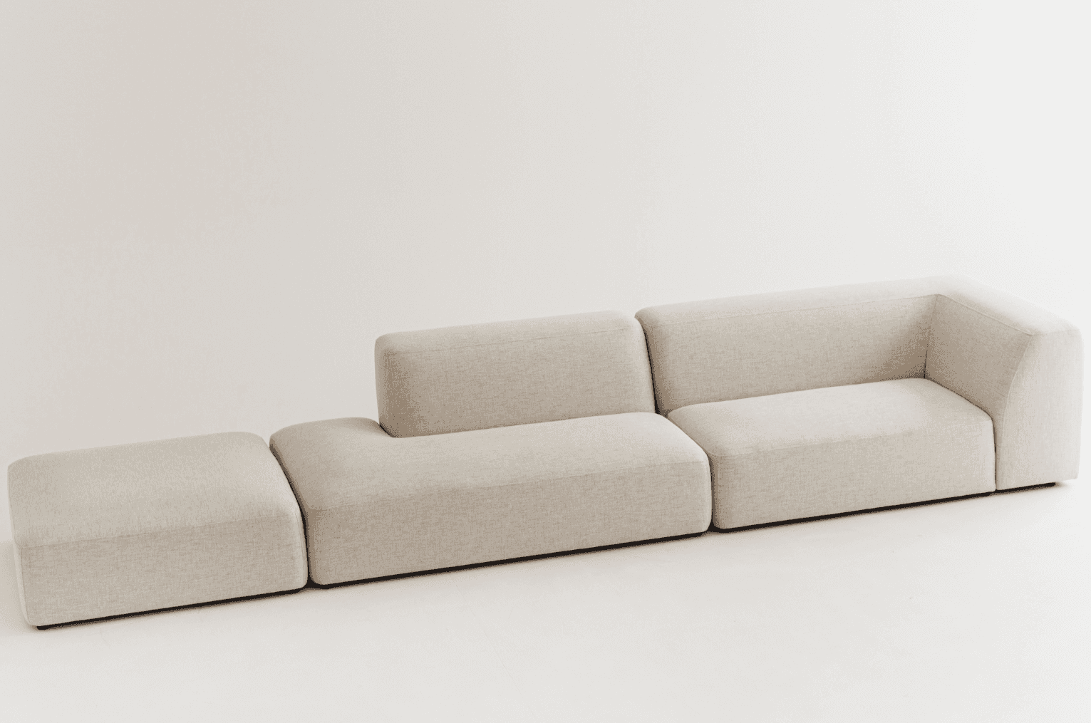 A light beige modular sectional sofa featuring three distinct components: a rectangular ottoman, a c… — free SKP 3D model