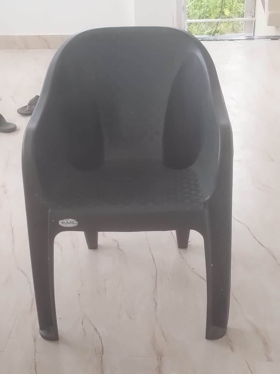 A dark grey, single-piece molded plastic armchair featuring integrated armrests and a slightly recli… — free OBJ 3D model