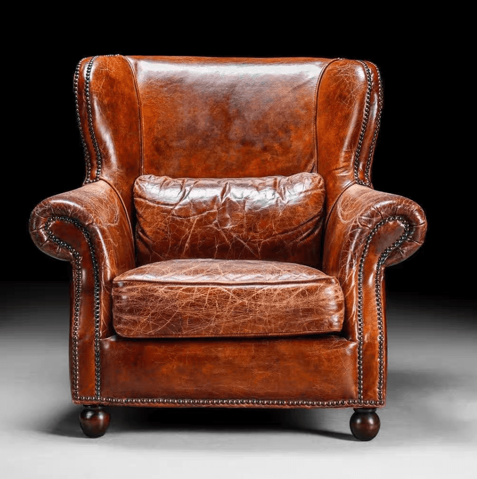 A traditional wingback armchair upholstered in rich, distressed brown leather, featuring prominent w… — free SKP 3D model