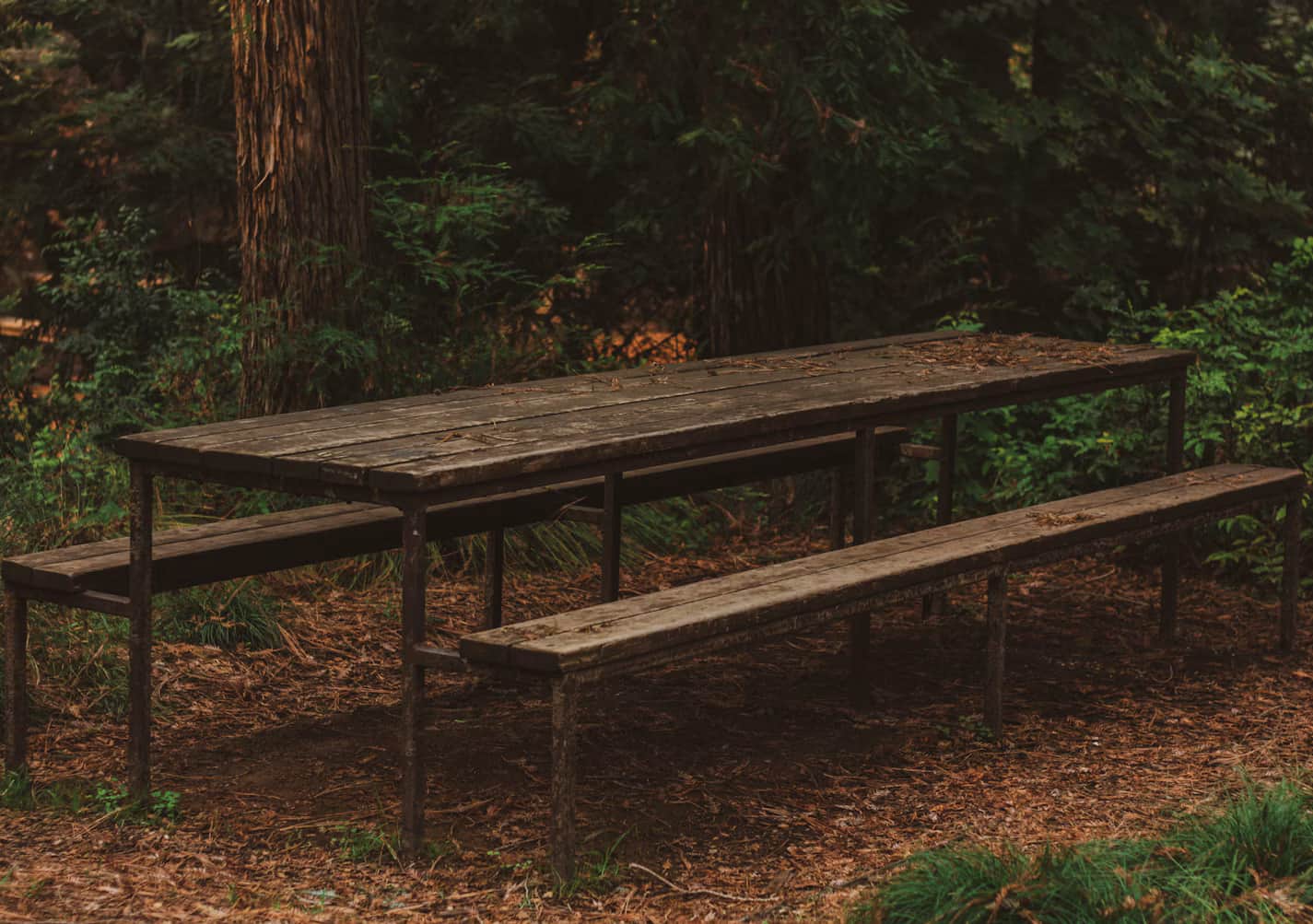 An outdoor picnic table with integrated benches, featuring a slatted dark wood tabletop and matching… — free FBX 3D model