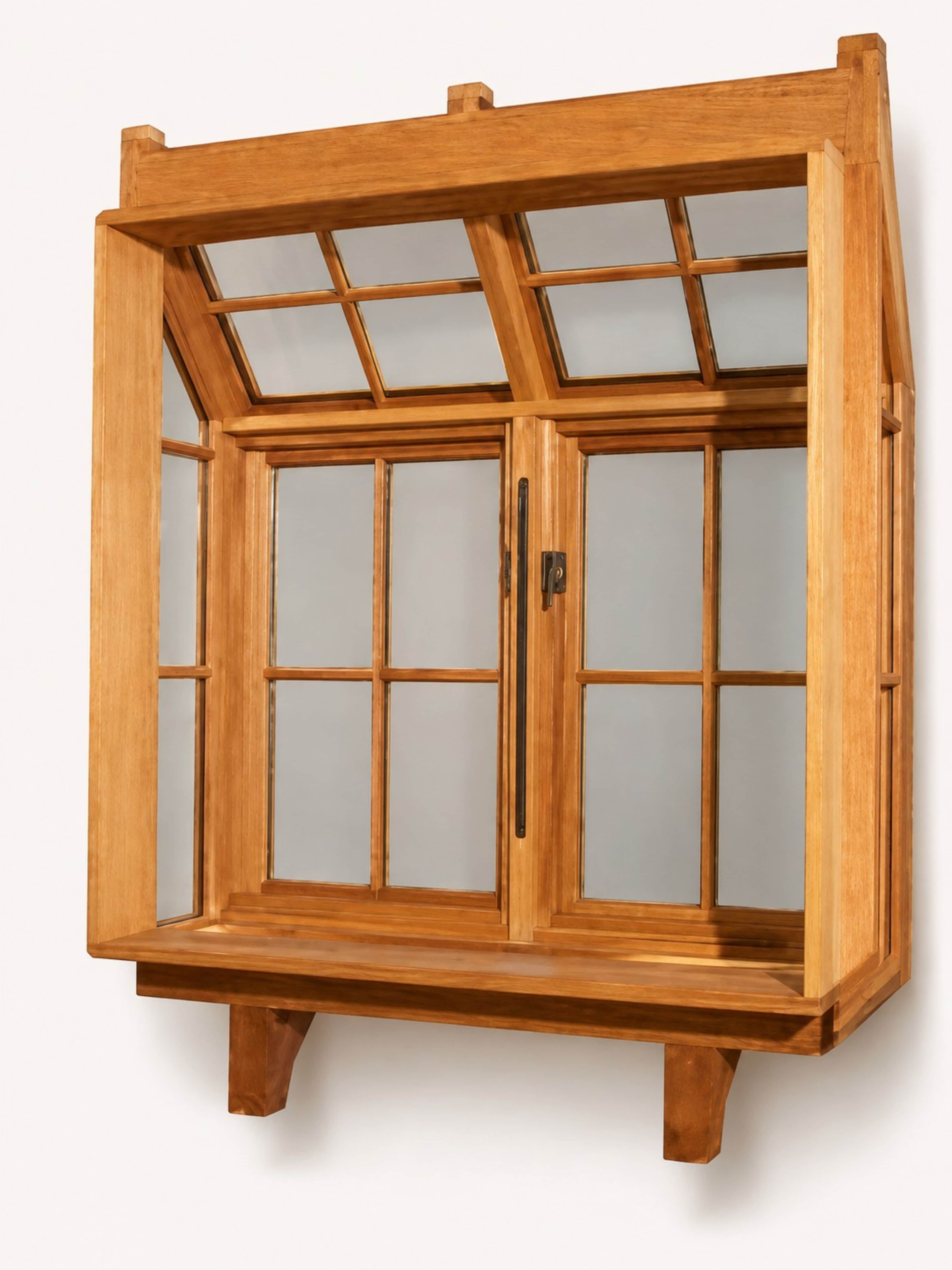 A wooden display cabinet featuring an angled, multi-paneled top section and a double-door lower sect… — 3D model