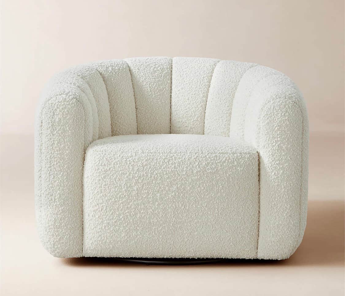 An off-white, channel-tufted bouclé swivel barrel chair. The chair features a rounded, plush design… — 3D model