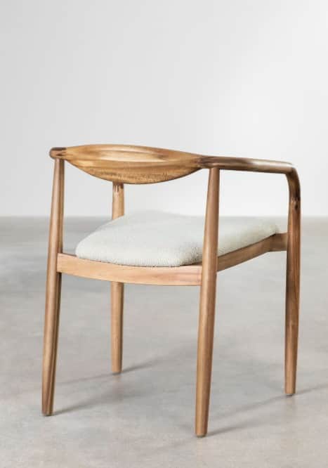A light-toned wooden armchair featuring a distinctive curved, carved backrest that extends seamlessl… — 3D model