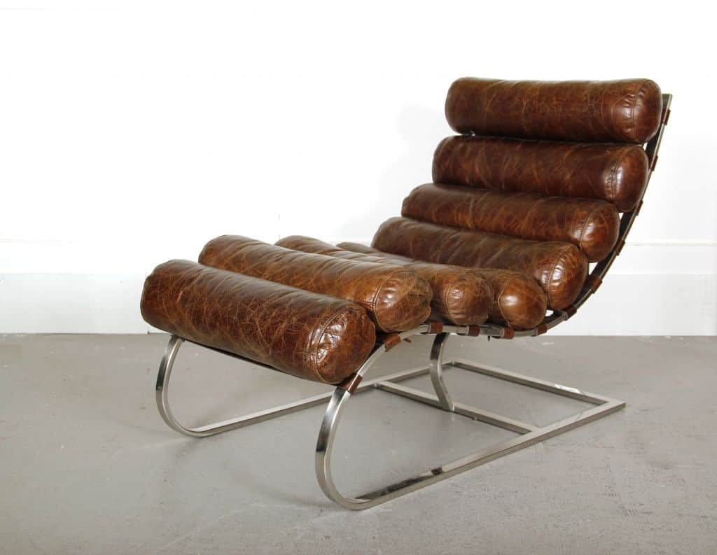 A modern lounge chair featuring a chrome metal frame and a series of brown leather bolsters for the… — free OBJ 3D model