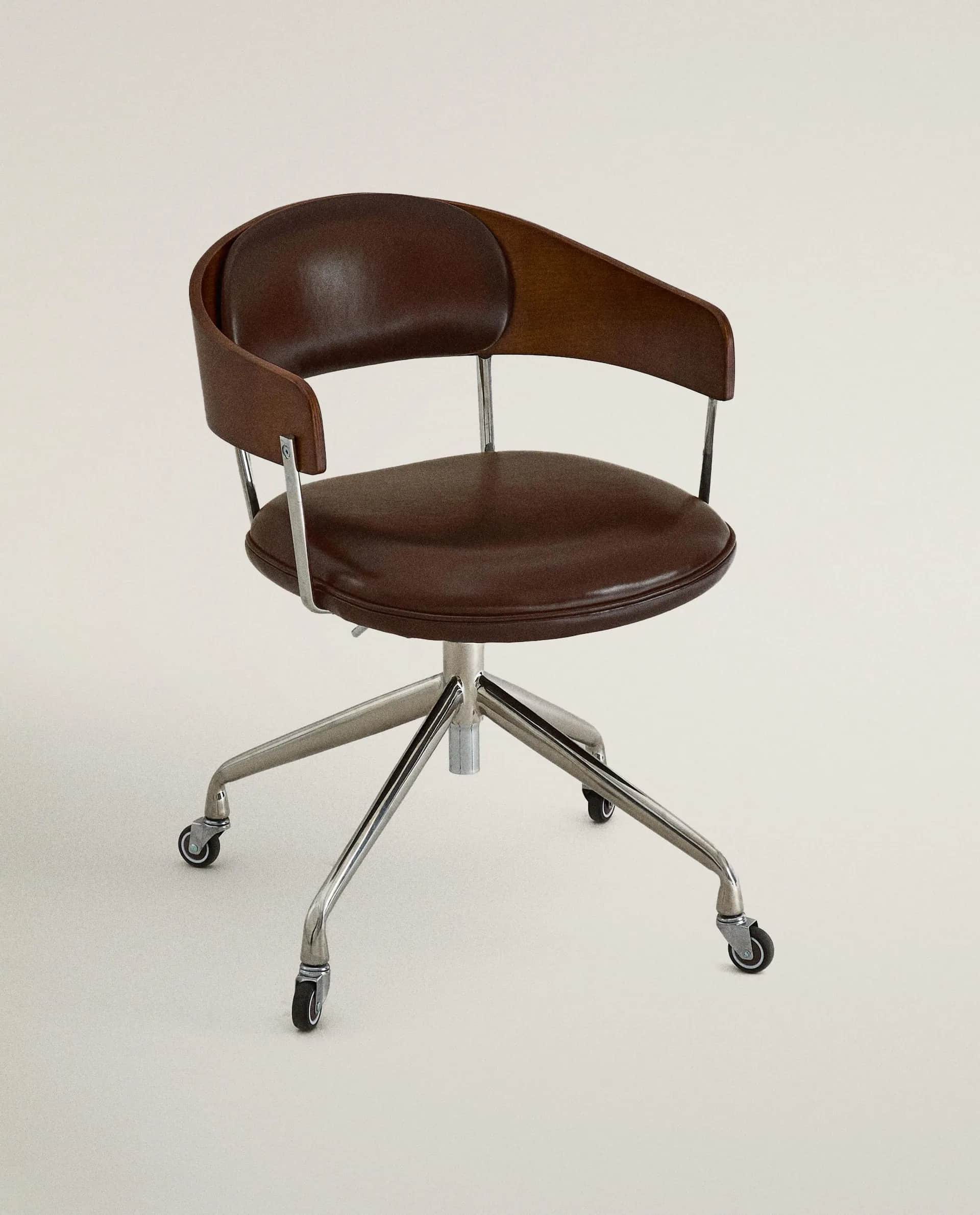 A brown leather upholstered swivel desk chair featuring a bentwood back shell and a five-star chrome… — 3D model