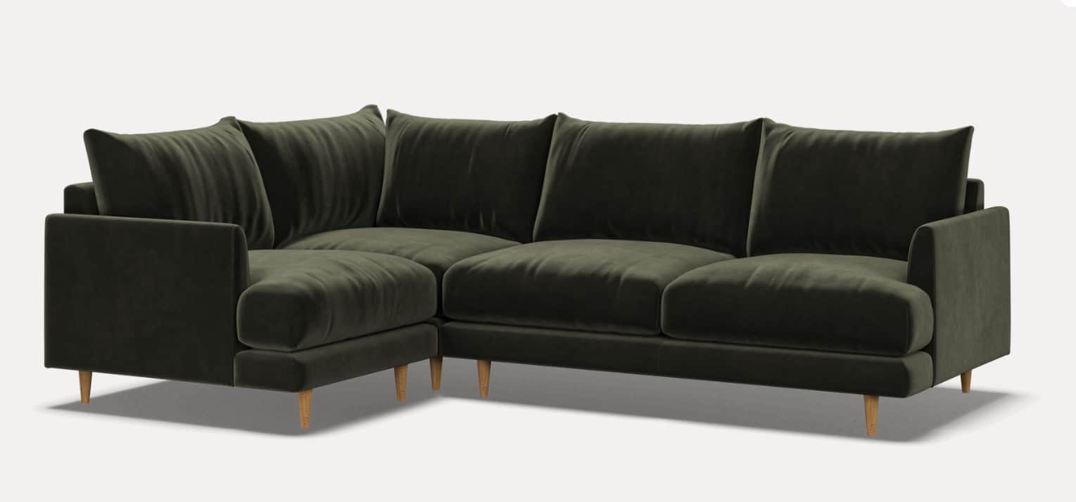 An L-shaped sectional sofa upholstered in dark olive green velvet, featuring a contemporary design w… — 3D model