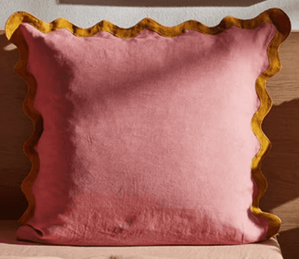 A square-shaped cushion with a pink fabric cover and a decorative mustard yellow ruffled edge. The c… — 3D model