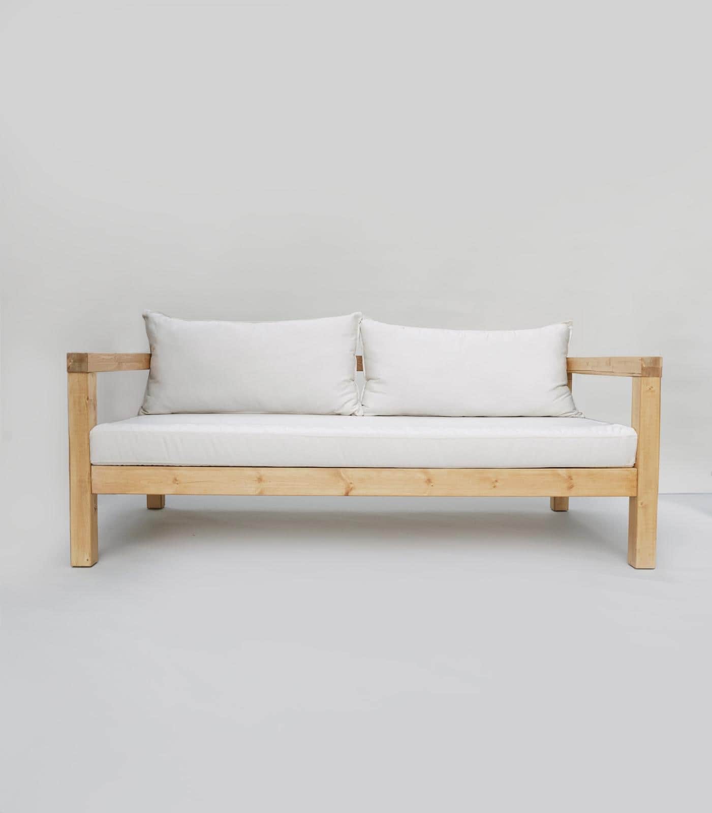 A modern, minimalist sofa with a wooden frame and white cushions. The sofa has a visible wooden stru… — 3D model