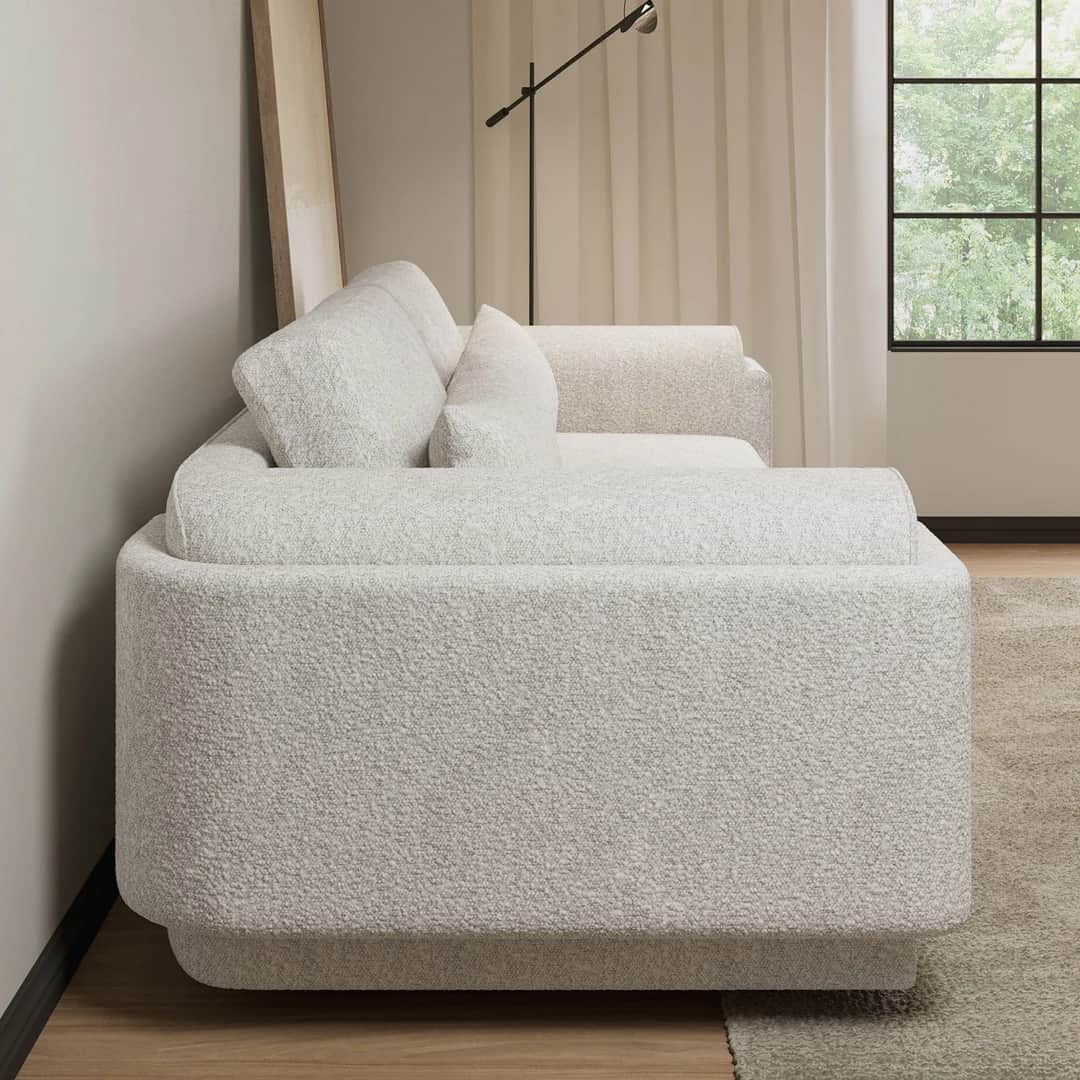 A contemporary sofa with a rounded, sculptural form. It features a textured boucle upholstery and in… — 3D model