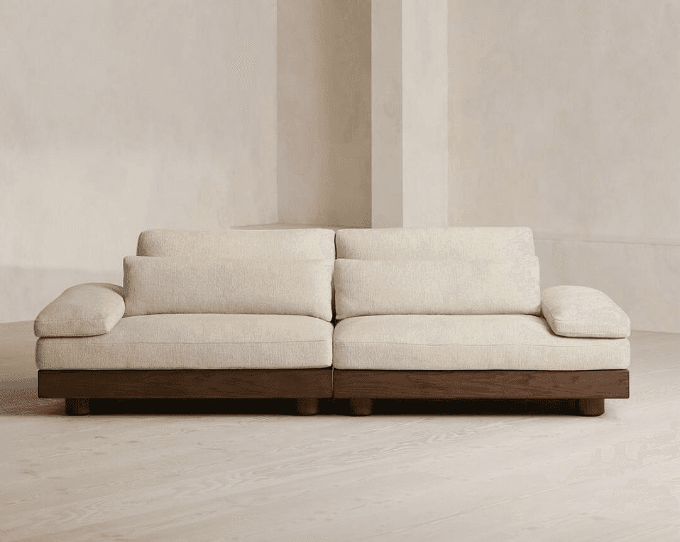 A modern, low-profile sofa with a sectional appearance, featuring a thick, upholstered base and seat… — free GLTF 3D model