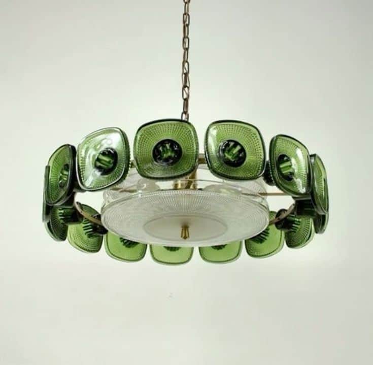 A circular chandelier featuring a brass-toned metal frame and numerous square-shaped, textured green… — 3D model