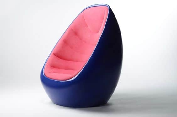 A modern armchair with a distinctive egg-like shape. The exterior shell is a deep, glossy navy blue,… — free OBJ 3D model