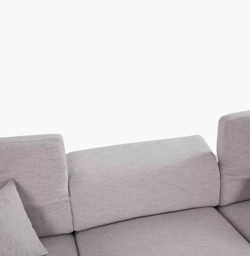 A section of a light gray, upholstered sofa is visible against a white background. The sofa features… — free GLTF 3D model