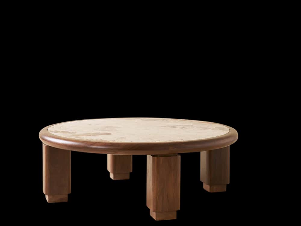 A low, round coffee table featuring a light-colored natural stone top, likely travertine, set within… — 3D model