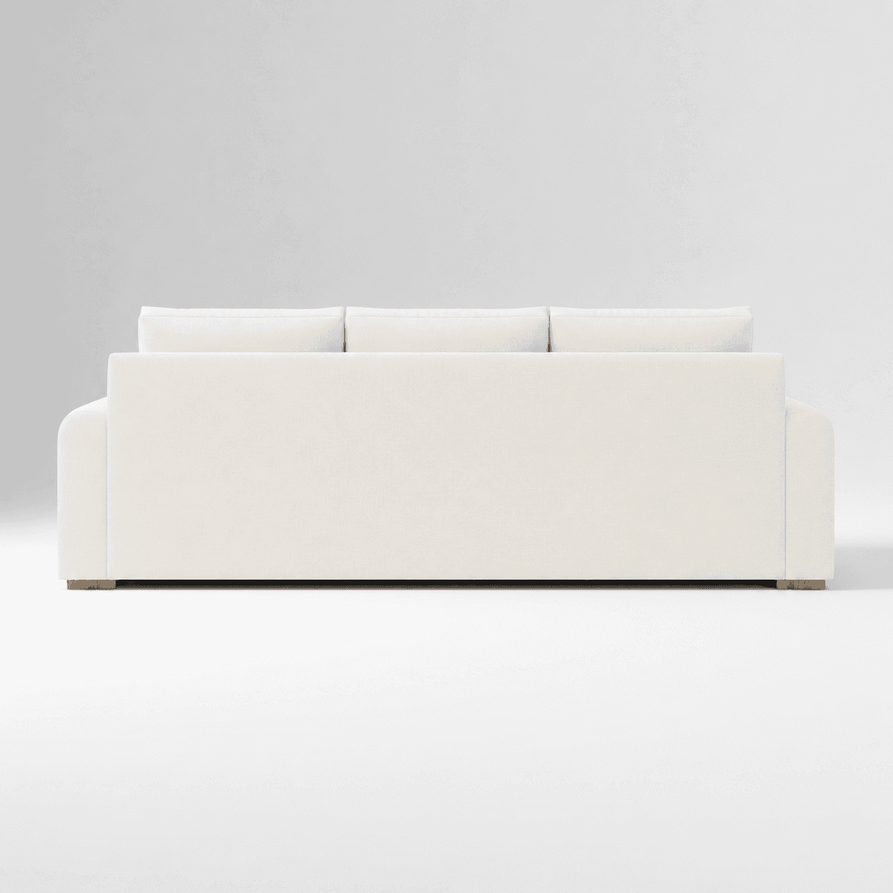 A contemporary three-seater sofa, viewed from the rear, featuring three loose back cushions and a lo… — 3D model