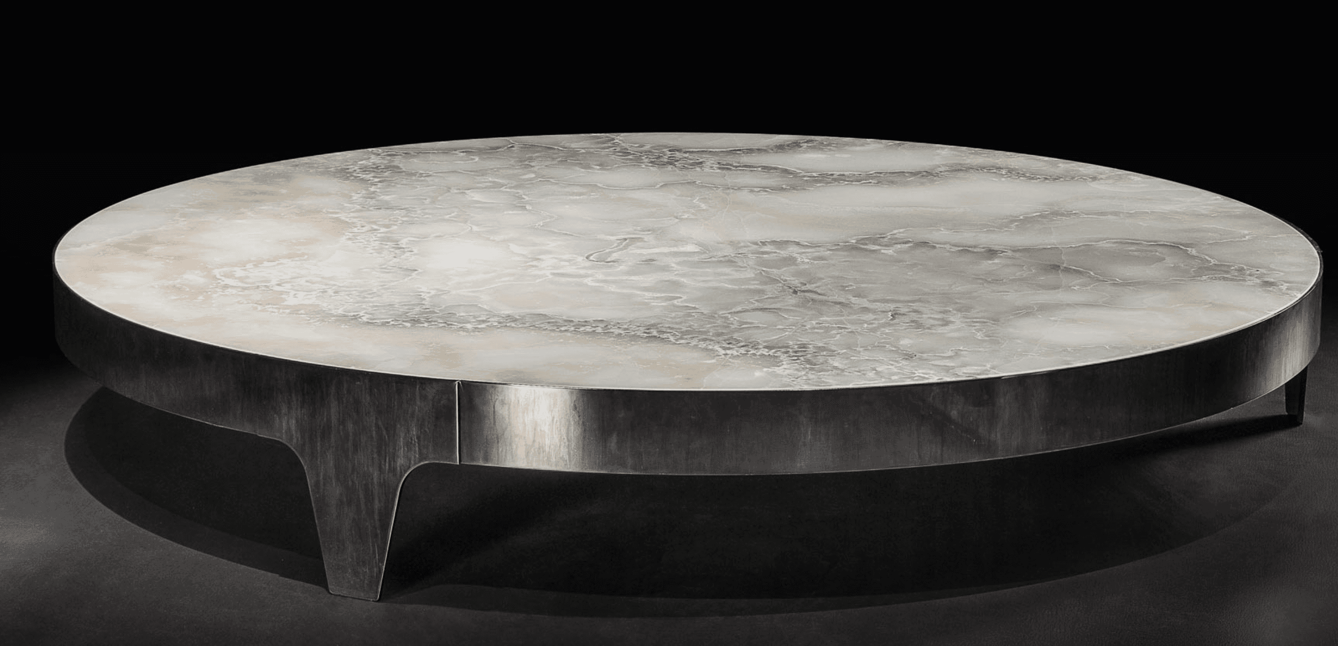 A round coffee table featuring a polished onyx tabletop with natural variegated patterns in white, b… — 3D model
