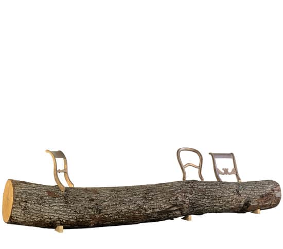 A long, raw, unrefined tree log functions as the main seating surface, supported by smaller wooden b… — 3D model