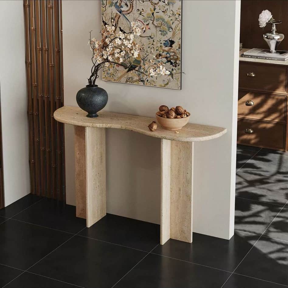 A D-shaped console table crafted entirely from beige travertine, featuring a solid, monolithic const… — 3D model