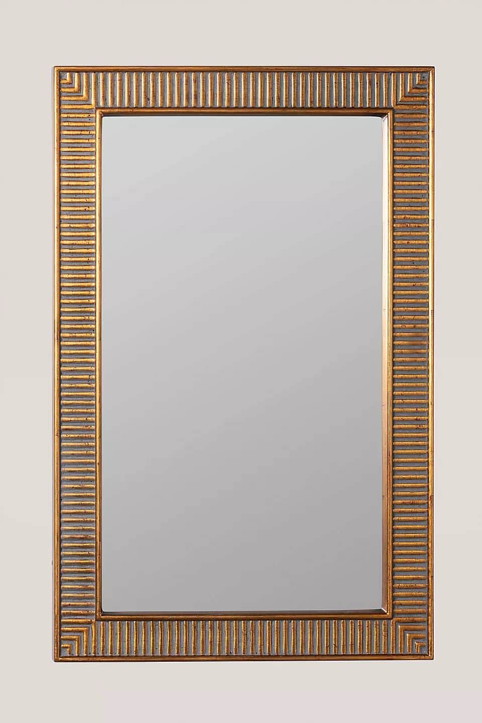 A rectangular wall mirror with a prominent gold-finished frame. The frame features a distinct geomet… — 3D model