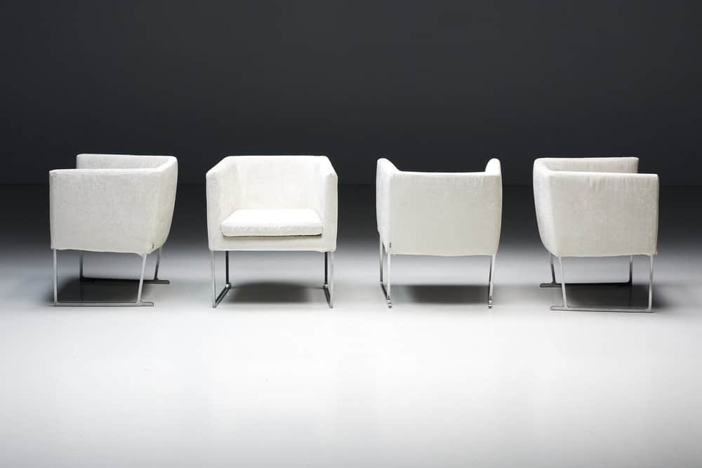 A set of four identical armchairs with a modern design. Each armchair features a cube-like upholster… — free OBJ 3D model