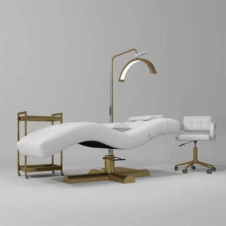 A modern white upholstered salon treatment chair featuring a contoured, reclining form and a gold-fi… — free STL 3D model