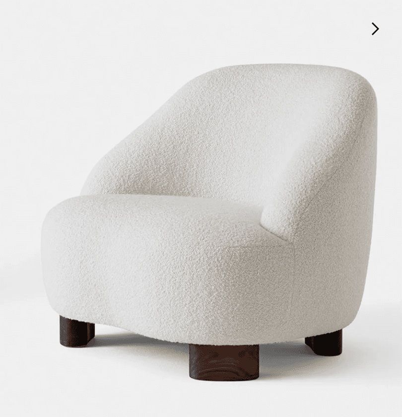 A contemporary lounge chair featuring a rounded, sculptural silhouette and upholstered in a cream-co… — 3D model