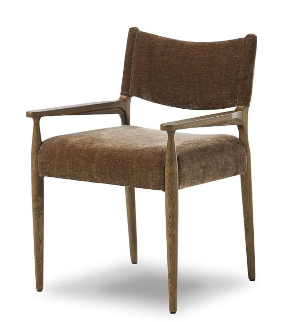 A contemporary armchair featuring a solid wood frame and plush upholstered seating. The frame is con… — 3D model