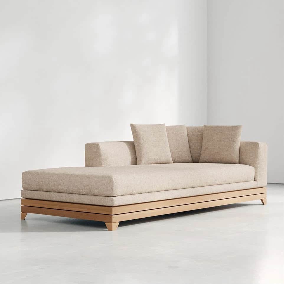 A contemporary chaise lounge featuring a low-profile design, upholstered in a textured beige fabric,… — 3D model