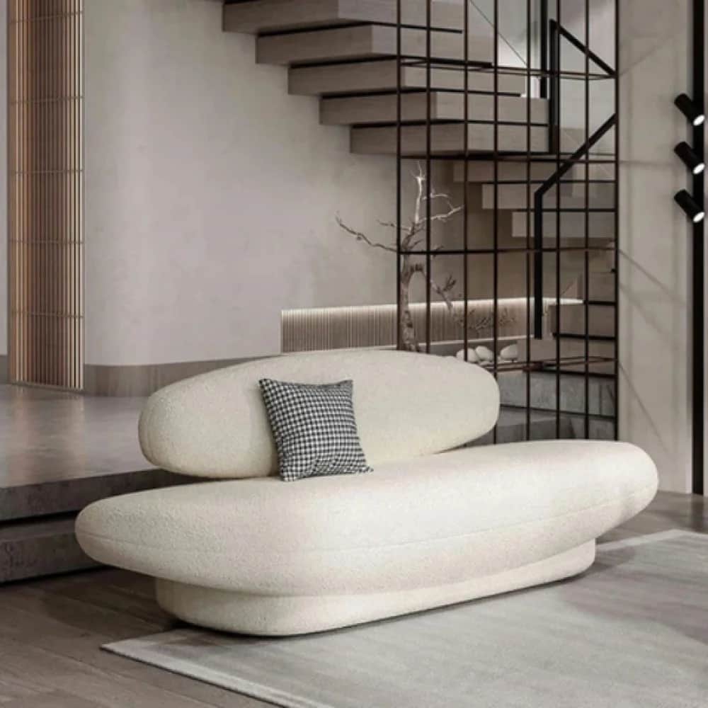 A contemporary, organic-shaped sofa upholstered in a cream bouclé fabric, featuring a long, low base… — 3D model