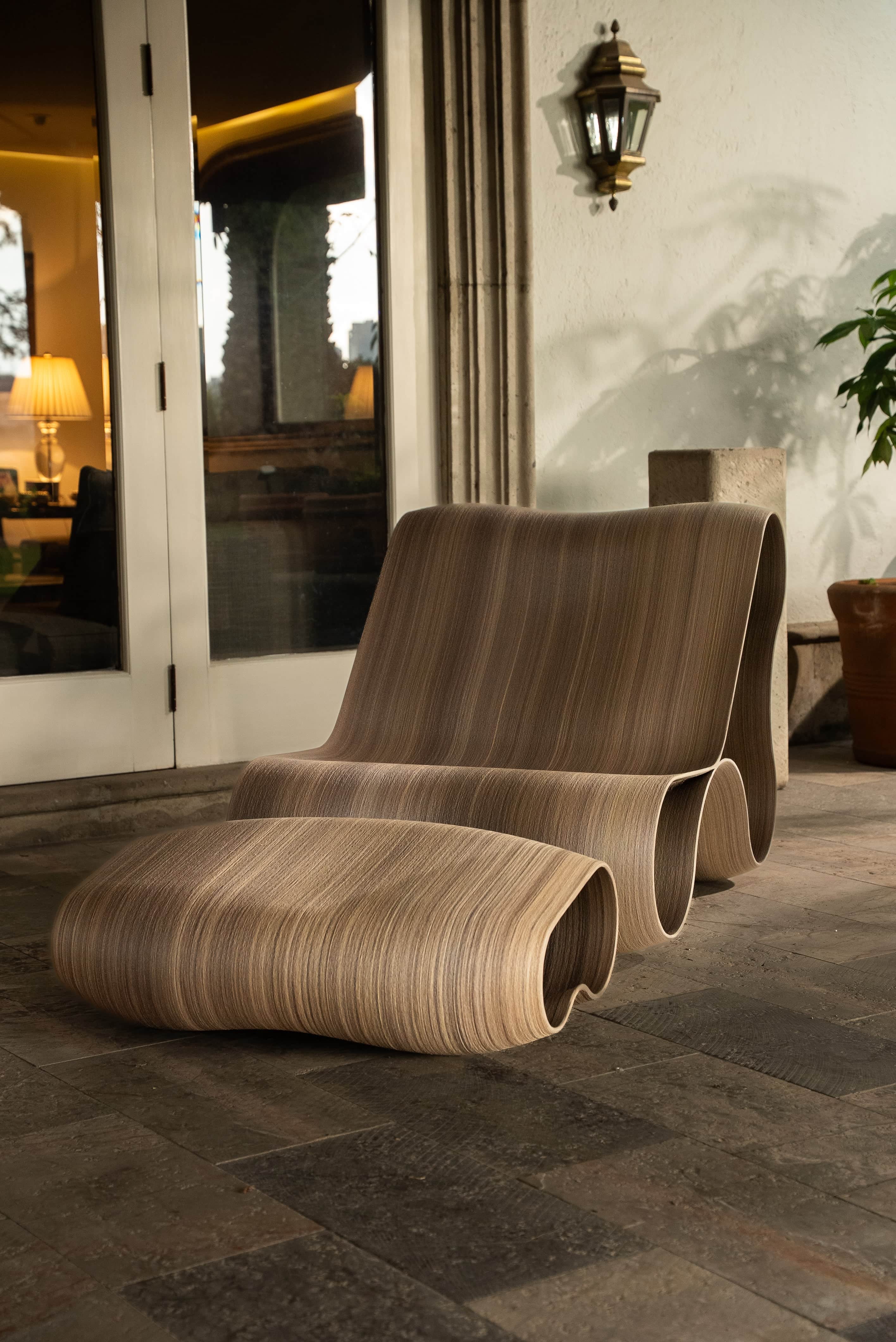 A contemporary lounge chair and ottoman set, characterized by a fluid, wave-like design. The chair f… — free OBJ 3D model