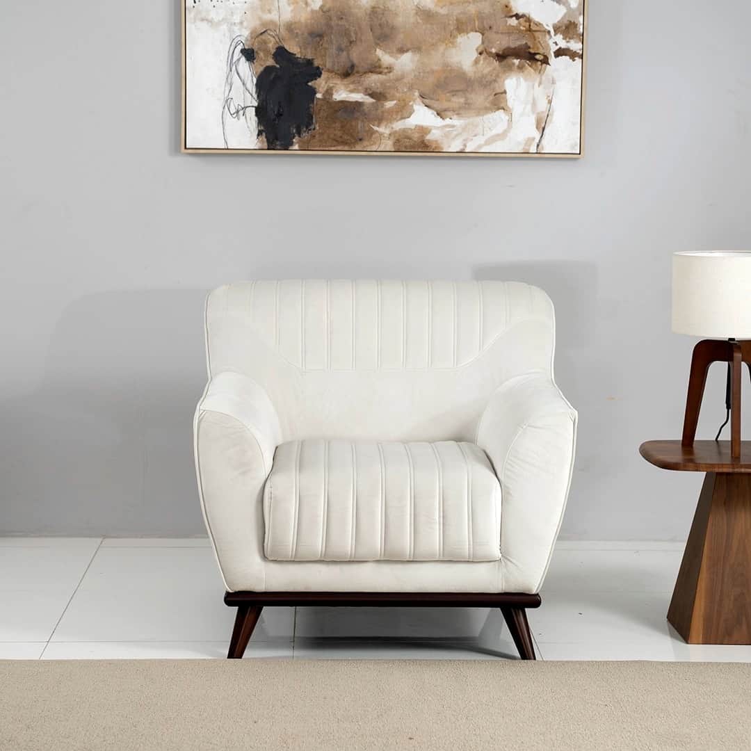 A modern upholstered armchair featuring channel tufting on the backrest and seat, rendered in an off… — 3D model