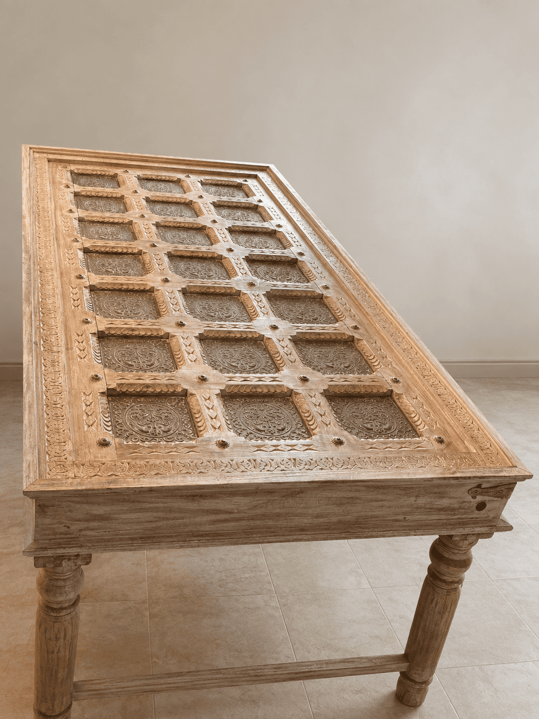 A rectangular coffee table crafted from light-toned wood, featuring extensively carved details on it… — 3D model
